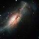 A color composite image of SN 2018zd, the bright dot at center right, and host galaxy NGC 2146 at left.